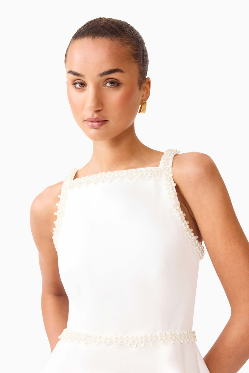 White Elliatt Stella A-Line Mini Dress displayed on a hanger with a clean background, showcasing its stylish design and flowy silhouette.