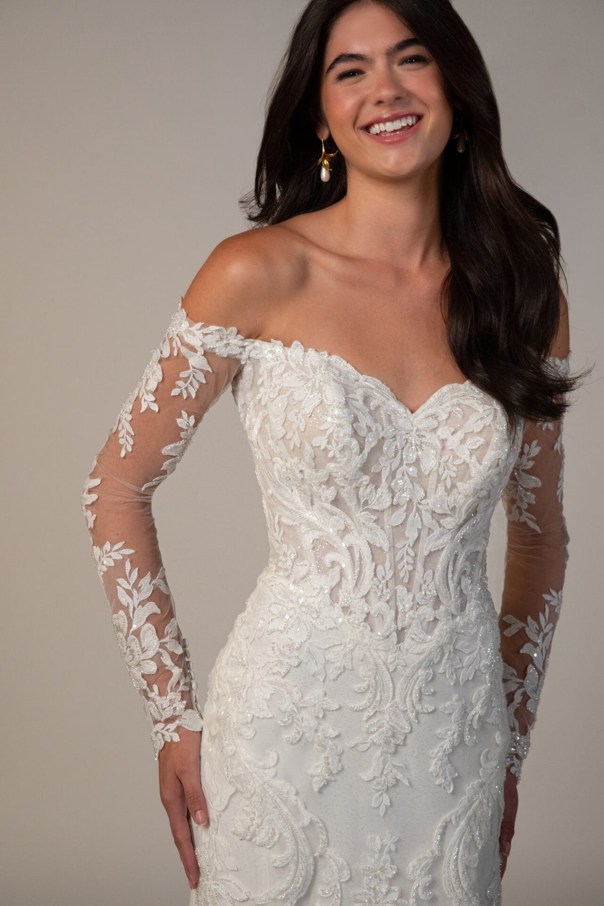 Stella York wedding gown by Mckinley, featuring elegant lace details and a flowing train, showcased in a full-length front view.