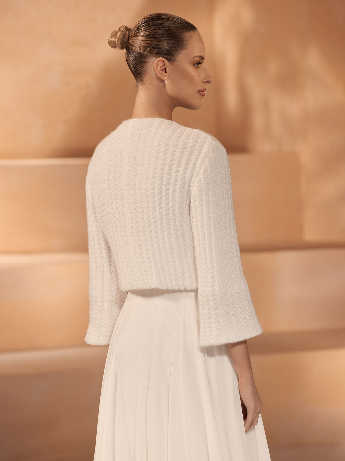 Bianco Evento bridal knitted cardigan accessory, soft cream color, fitted design, perfect for wedding or special occasion attire.