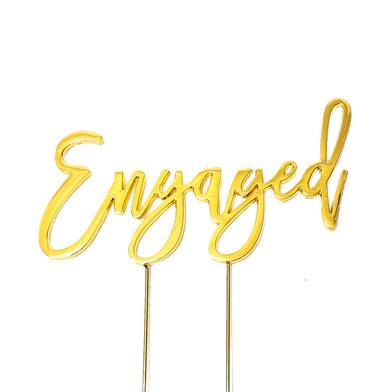 Gold "Engaged" cake topper from Cake and Candle giftware, featuring elegant lettering for special occasions